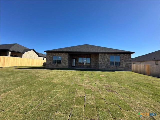 rear view of house with a yard