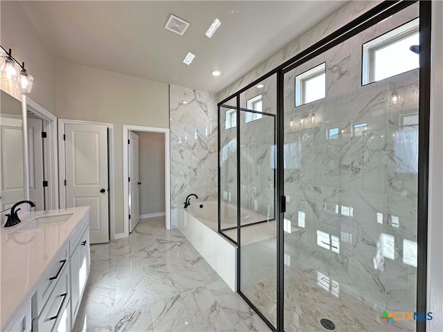 bathroom featuring vanity and independent shower and bath