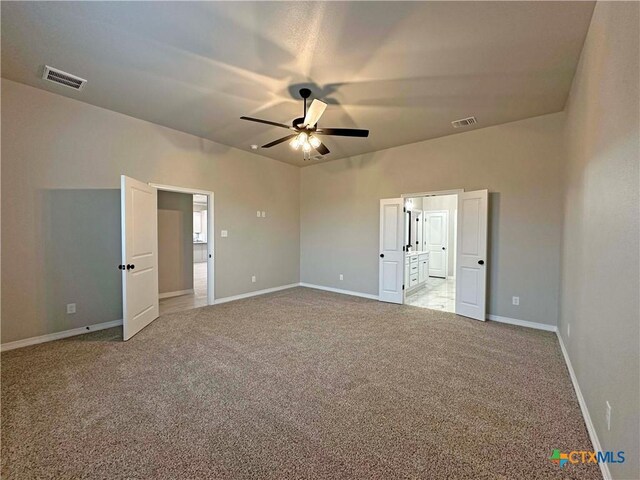 spare room with light colored carpet and ceiling fan