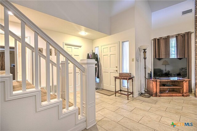 3618 Bobcat Trl, Temple, TX 76502 - foyer with stairs, a towering ceiling, and light tile patterned flooring