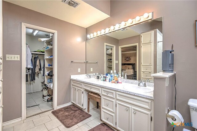 3618 Bobcat Trl, Temple, TX 76502 - bathroom with double vanity, tile patterned flooring, and a walk in closet