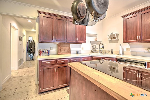 3618 Bobcat Trl, Temple, TX 76502 - kitchen featuring butcher block countertops, a sink, light tile patterned flooring, crown molding, and baseboards