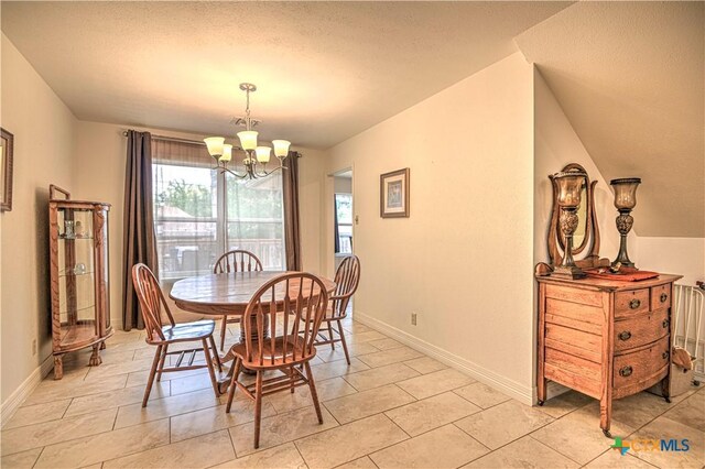 3618 Bobcat Trl, Temple, TX 76502 - dining area with a chandelier, baseboards, a textured ceiling, and light tile patterned floors