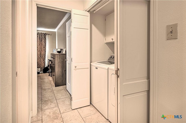 3618 Bobcat Trl, Temple, TX 76502 - laundry room with cabinet space, light tile patterned flooring, and separate washer and dryer