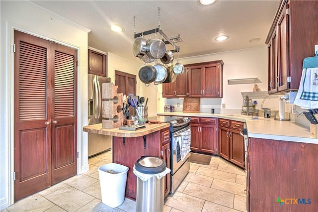 3618 Bobcat Trl, Temple, TX 76502 - kitchen featuring a sink, appliances with stainless steel finishes, light countertops, crown molding, and reddish brown cabinets