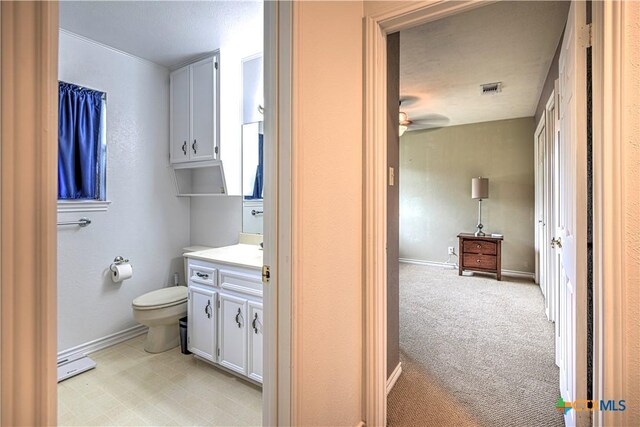 3618 Bobcat Trl, Temple, TX 76502 - bathroom featuring vanity, toilet, baseboards, and a ceiling fan
