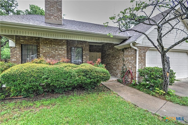 3618 Bobcat Trl, Temple, TX 76502 - entrance to property featuring brick siding, a chimney, an attached garage, and a shingled roof