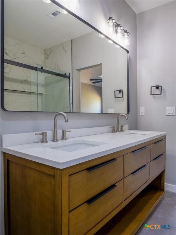 bathroom featuring vanity and a shower with door