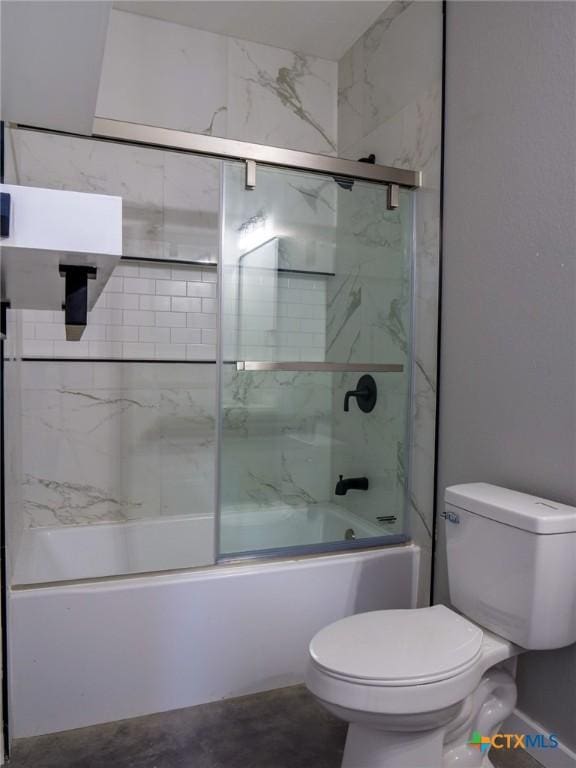 bathroom featuring toilet and combined bath / shower with glass door