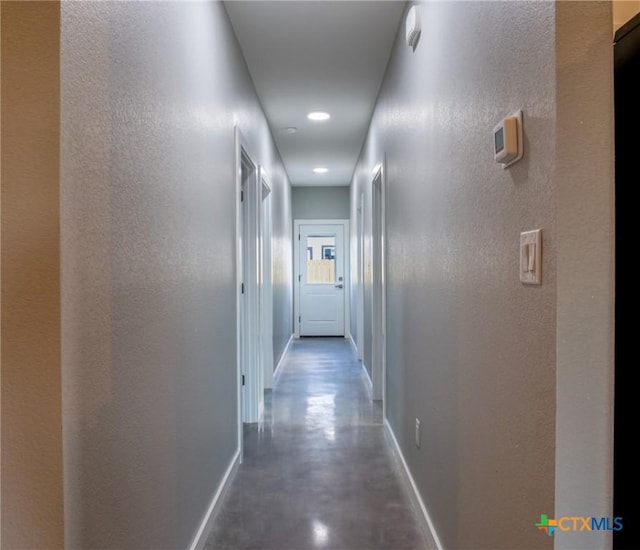 hallway featuring concrete flooring