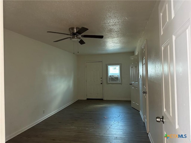 entryway featuring a textured ceiling, cooling unit, ceiling fan, and dark wood-type flooring