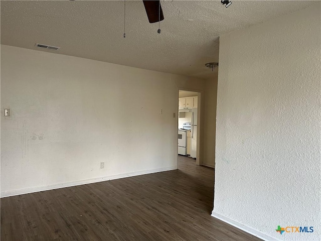 unfurnished room with ceiling fan, dark hardwood / wood-style flooring, and a textured ceiling