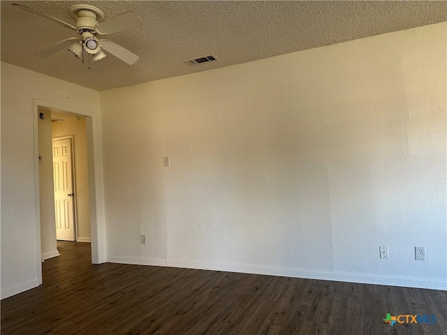 spare room with dark hardwood / wood-style floors, ceiling fan, and a textured ceiling