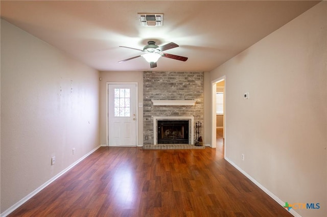 unfurnished living room with a ceiling fan, wood finished floors, visible vents, and baseboards