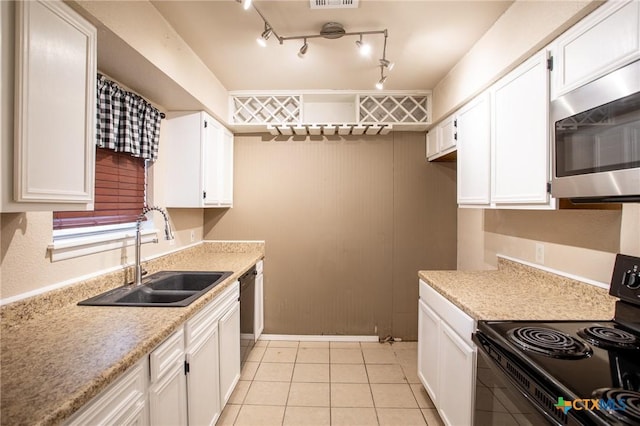 kitchen with black appliances, white cabinets, and a sink