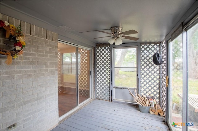 unfurnished sunroom featuring plenty of natural light and ceiling fan