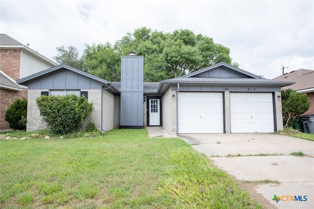 view of front of house featuring a garage, brick siding, board and batten siding, and a front yard