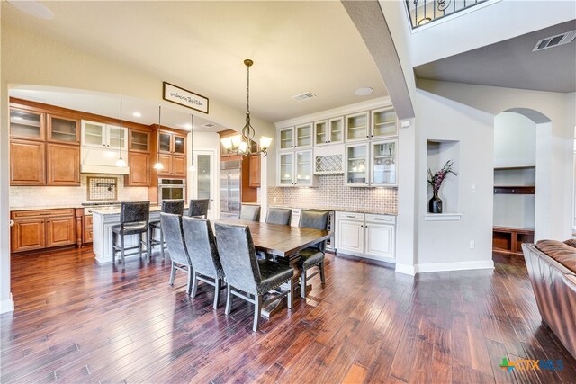 dining room featuring dark hardwood / wood-style flooring and a notable chandelier