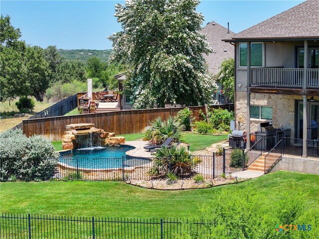 view of swimming pool with area for grilling and a yard