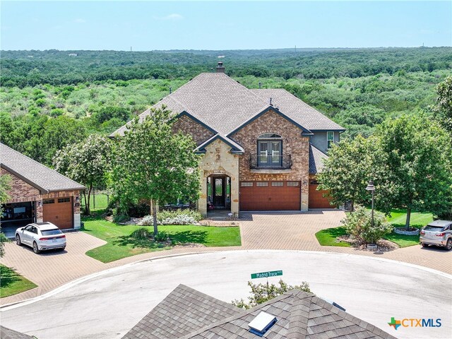 view of front of home with a front lawn and a garage