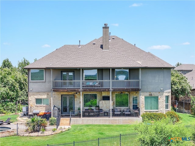 rear view of property featuring a balcony, a lawn, outdoor lounge area, and a patio area