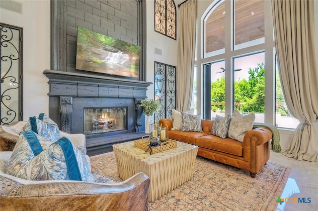 living area featuring a high ceiling and tile patterned floors