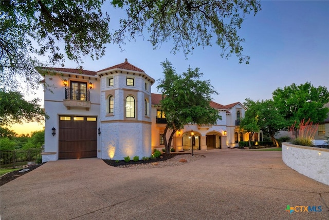 mediterranean / spanish home with a garage