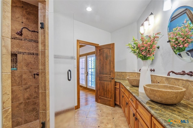 bathroom featuring hardwood / wood-style flooring, vanity, an enclosed shower, and french doors