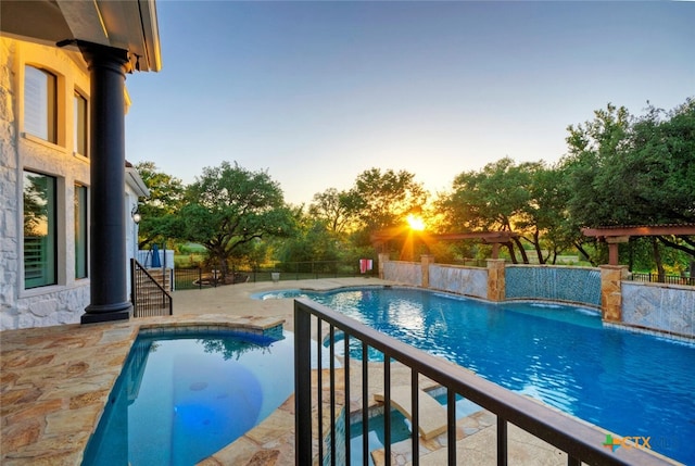 pool at dusk featuring a patio area