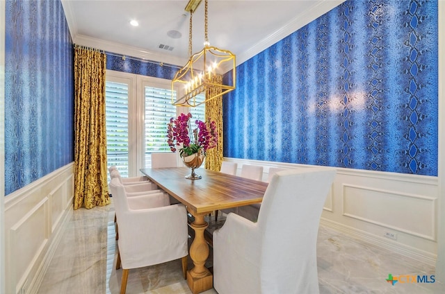 dining area with a notable chandelier and ornamental molding