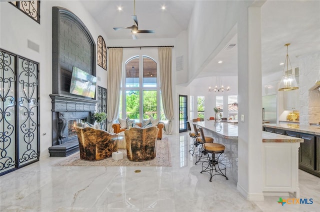 interior space with ceiling fan and high vaulted ceiling