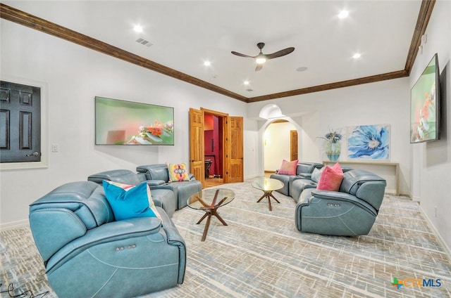 living room featuring ceiling fan and crown molding