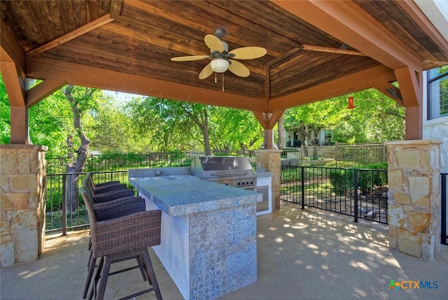 view of patio / terrace featuring area for grilling, an outdoor kitchen, and ceiling fan