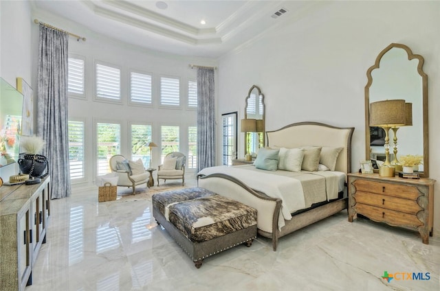 bedroom featuring ornamental molding, a towering ceiling, and a raised ceiling