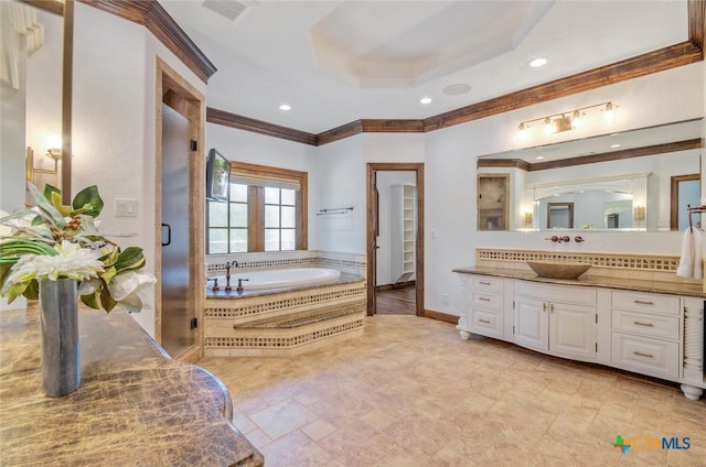 bathroom featuring vanity, a raised ceiling, crown molding, and separate shower and tub