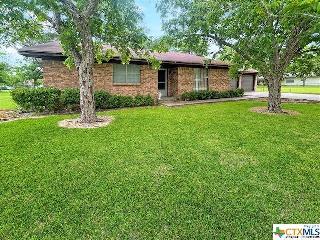 ranch-style house featuring a garage and a front lawn