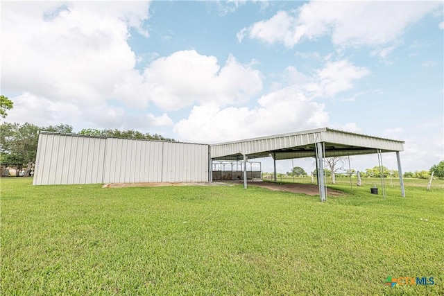 679 Royal Rd, Port Lavaca, TX 77979 - view of grassy yard featuring a pole building, a carport, and an outbuilding