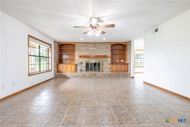 679 Royal Rd, Port Lavaca, TX 77979 - unfurnished living room with built in shelves, baseboards, ceiling fan, a fireplace, and recessed lighting