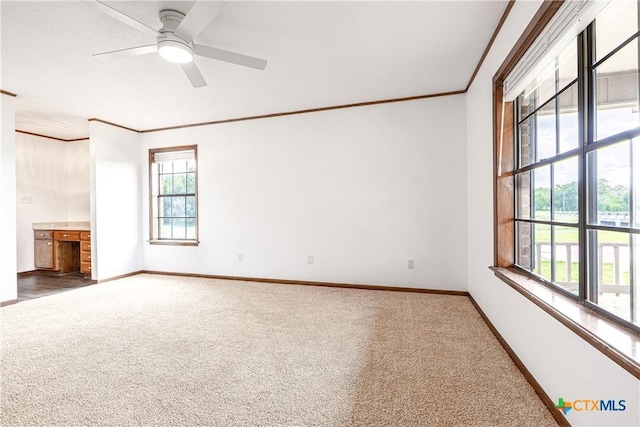 679 Royal Rd, Port Lavaca, TX 77979 - unfurnished living room featuring crown molding, carpet floors, baseboards, and ceiling fan