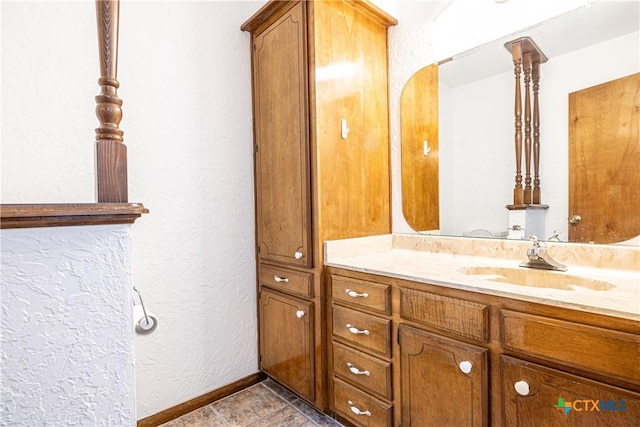 679 Royal Rd, Port Lavaca, TX 77979 - bathroom featuring a textured wall, vanity, and baseboards
