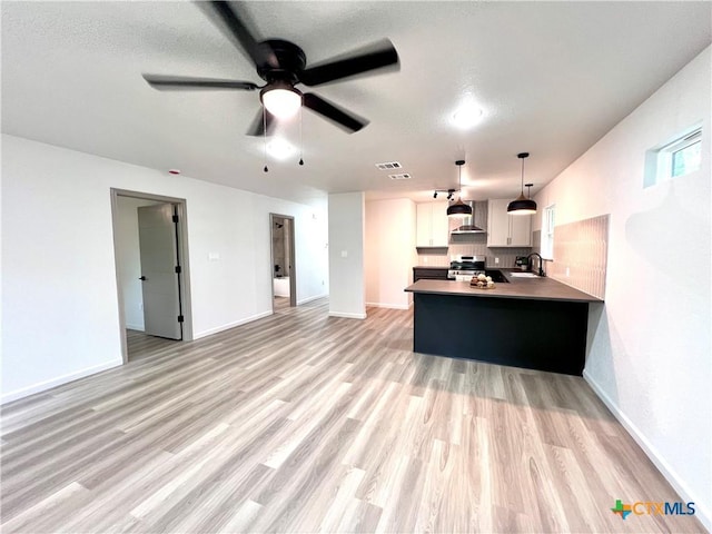 107 S 23rd St, Temple, TX 76504 - kitchen with a sink, ceiling fan, light wood-style flooring, white cabinets, and a peninsula