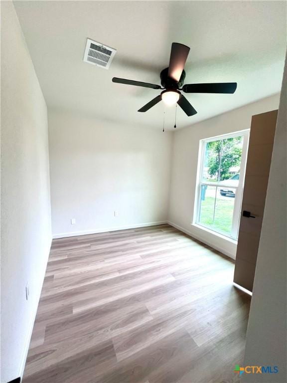 107 S 23rd St, Temple, TX 76504 - empty room with wood finished floors, a ceiling fan, and baseboards