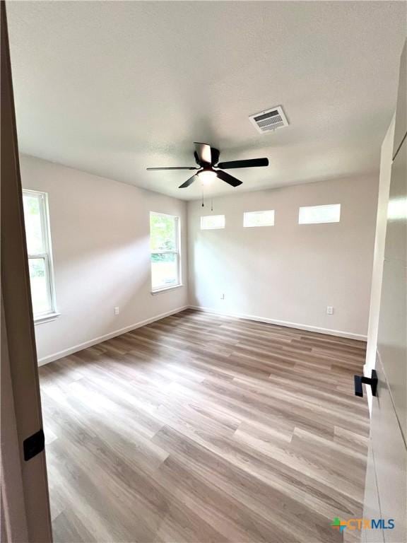 107 S 23rd St, Temple, TX 76504 - spare room with light wood-style floors, ceiling fan, and baseboards