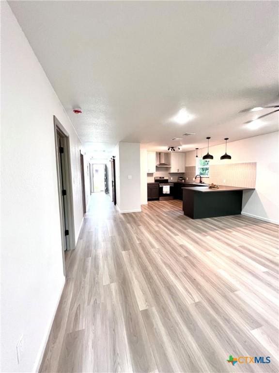 107 S 23rd St, Temple, TX 76504 - unfurnished living room with light wood finished floors and baseboards