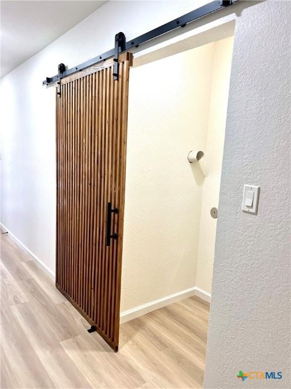 107 S 23rd St, Temple, TX 76504 - bathroom with wood finished floors, baseboards, and a textured wall