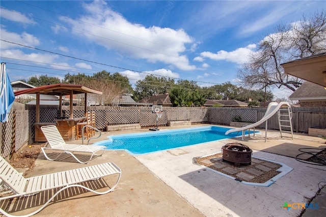 116 Guinevere St, Victoria, TX 77904 - view of pool featuring a patio, an outdoor fire pit, and a water slide