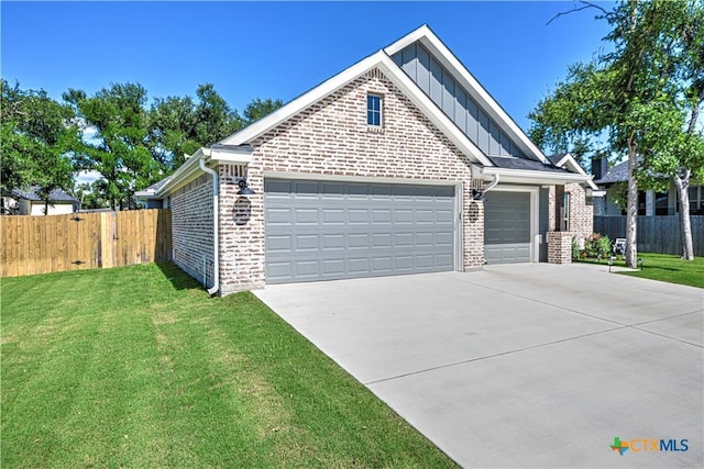 6129 Messina Dr, Temple, TX 76502 - view of front of home with board and batten siding, concrete driveway, a garage, and brick siding