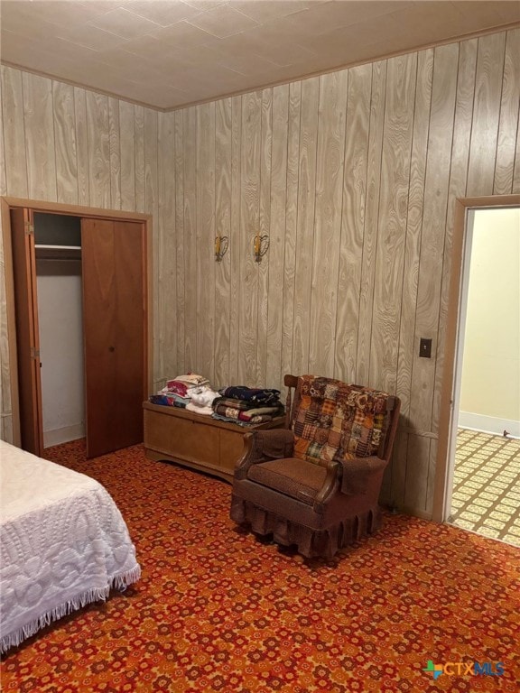 bedroom with wood walls and carpet flooring