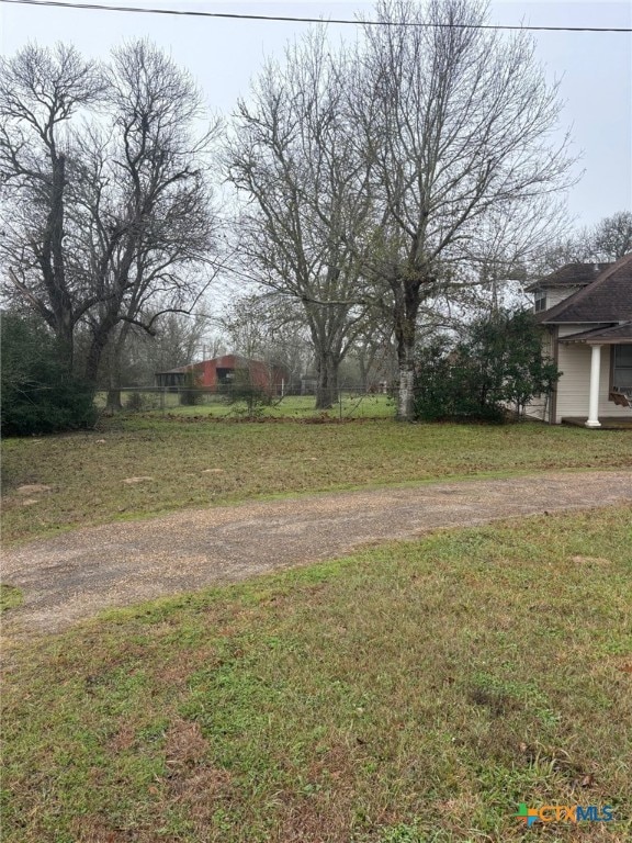 view of yard with dirt driveway