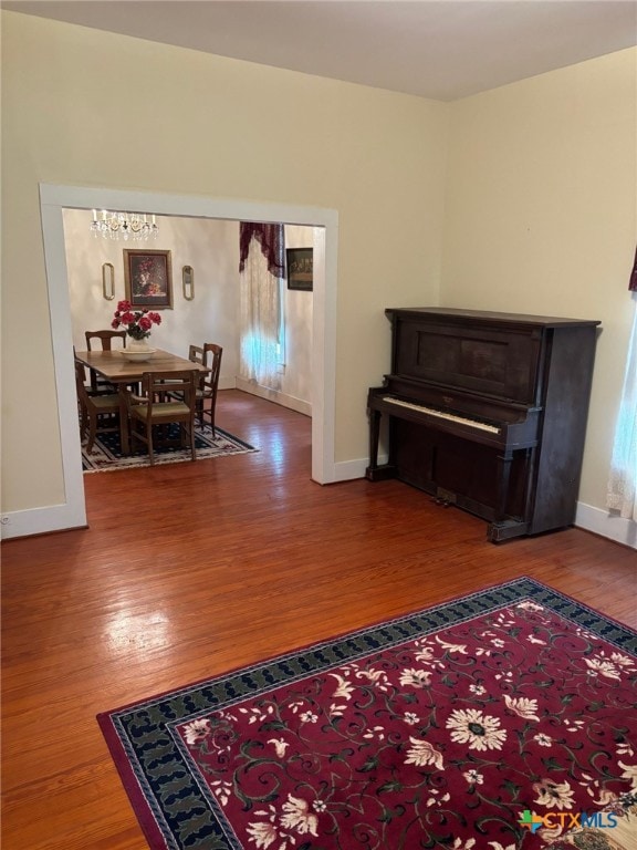 living area with wood finished floors and baseboards